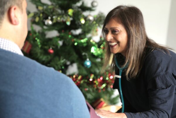 Hospice nurse helping a patient at Christmas